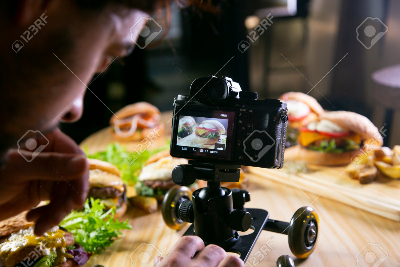 201497846-a-person-is-using-a-camera-to-take-a-picture-of-food-and-beverage-on-a-table